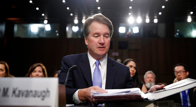 President Donald Trump's Supreme Court nominee, Brett Kavanaugh readies his papers before he testifies before the Senate Judiciary Committee on Capitol Hill. (AP Photo/Alex Brandon)