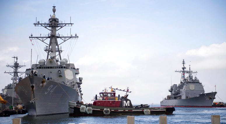 In this Monday, Sept. 10, 2018, photo released by the U.S. Navy, the guided-missile destroyer USS Nitze departs Naval Station Norfolk after the announcement of Hurricane Florence, in Norfolk, Va.