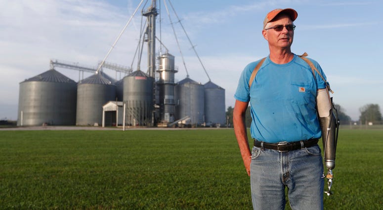 Jack Maloney poses in front of the grain bins on his Little Ireland Farms in Brownsburg, Ind., Wednesday, Sept. 12, 2018. Maloney, who farms about 2,000 acres in Hendricks Count, said the aid for farmers is "a nice gesture"