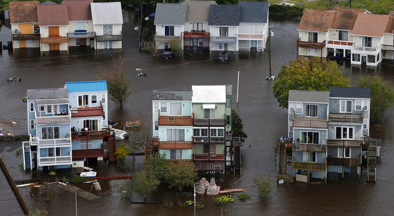 Homes along the New River are flooded as a result of high tides and rain from hurricane Florence which moved through the area in Jacksonville, N.C., Sunday, Sept. 16, 2018. (AP Photo/Steve Helber)