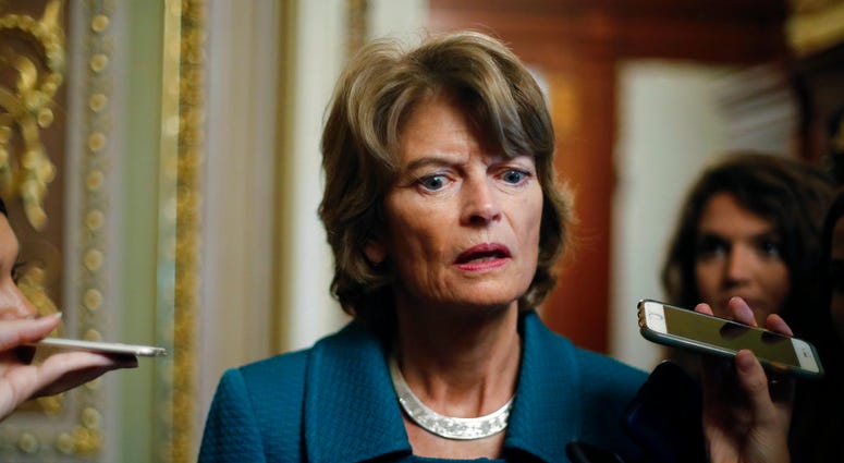 Sen. Lisa Murkowski, R-Alaska, speaks to members of the media after a vote to advance Brett Kavanaugh's nomination to the Supreme Court, on Capitol Hill, Friday, Oct. 5, 2018