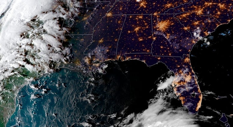 This satellite image provided by the National Oceanic and Atmospheric Administration shows a view of Tropical Storm Michael, lower right, churning as it heads toward the Florida Panhandle, Sunday, Oct. 7, 2018, at 6:52 p.m. Eastern Time. (NOAA via AP)