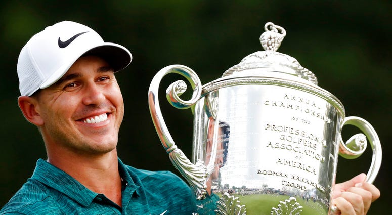 n this Aug. 12, 2018, file photo, Brooks Koepka holds the Wanamaker Trophy after he won the PGA Championship golf tournament at Bellerive Country Club, in St. Louis.