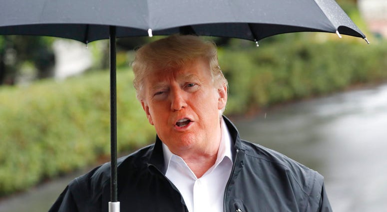 President Donald Trump stops to talk to members of the media before walking across the South Lawn of the White House in Washington on Monday, Oct. 15, 2018. (AP Photo/Pablo Martinez Monsivais)