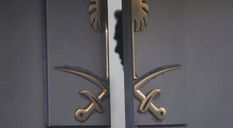 A security personnel is seen inside the entrance of the Saudi Arabia's Consulate in Istanbul, Tuesday, Oct. 16, 2018. (AP Photo/Petros Giannakouris)