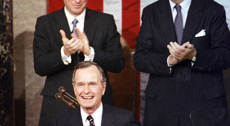 n this Jan. 31, 1990, file photo, President George H.W. Bush receives applause from Vice President Dan Quayle, left, and House Speaker Thomas Foley prior to delivering his first State of the Union address on Capitol Hill in Washington