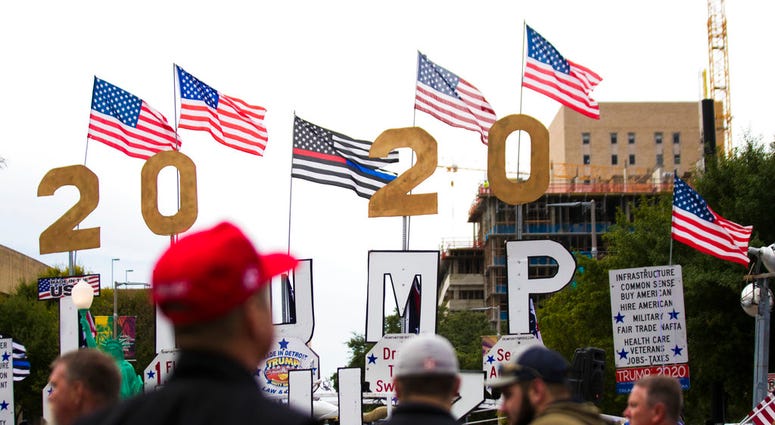 People arrive before a scheduled President Donald Trump rally for Sen. Ted Cruz at the Toyota Center on Monday, Oct. 22, 2018, in Houston.