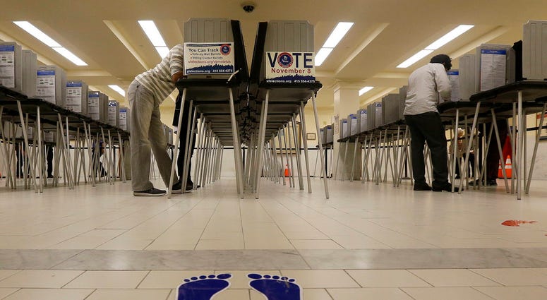 In this Nov. 8, 2016, file photo, voters cast ballots at City Hall in San Francisco. (AP Photo/Jeff Chiu, File)