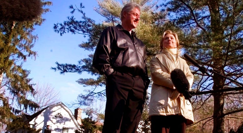 In this Jan. 6, 2000 file photo, Bill and Hillary Clinton stand in the driveway of their new home in Chappaqua, N.Y. (AP Photo, File)