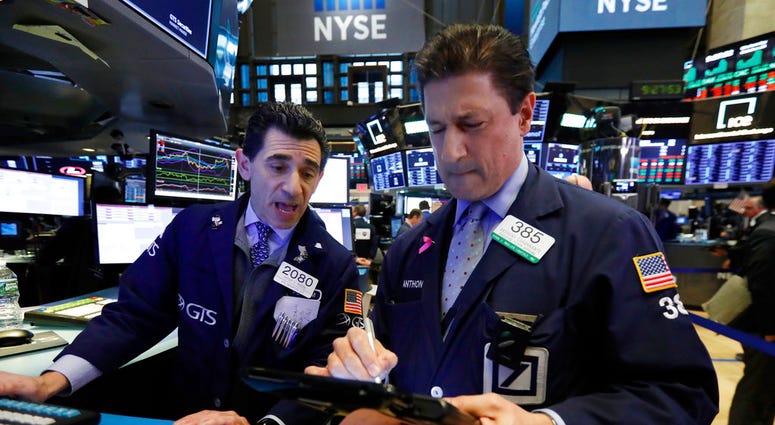Specialist Peter Mazza, left, and trader Anthony Carannante work on the floor of the New York Stock Exchange, Wednesday, Oct. 24, 2018. (AP Photo/Richard Drew)