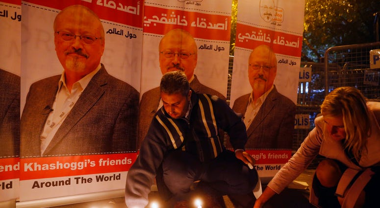Activists protesting the killing of Saudi journalist Jamal Khashoggi hold a candlelight vigil outside Saudi Arabia's consulate in Istanbul, Thursday, Oct. 25, 2018. (AP Photo/Lefteris Pitarakis)