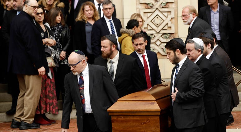 A casket is carried out of Rodef Shalom Congregation after the funeral services for brothers Cecil and David Rosenthal, Tuesday, Oct. 30, 2018, in Pittsburgh. (AP Photo/Matt Rourke)