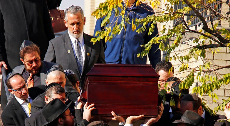 Pallbearers carry the casket of Joyce Fienberg from the Beth Shalom Synagogue following a funeral service in the Squirrel Hill neighborhood of Pittsburgh, Wednesday, Oct. 31, 2018. (AP Photo/Gene J. Puskar)