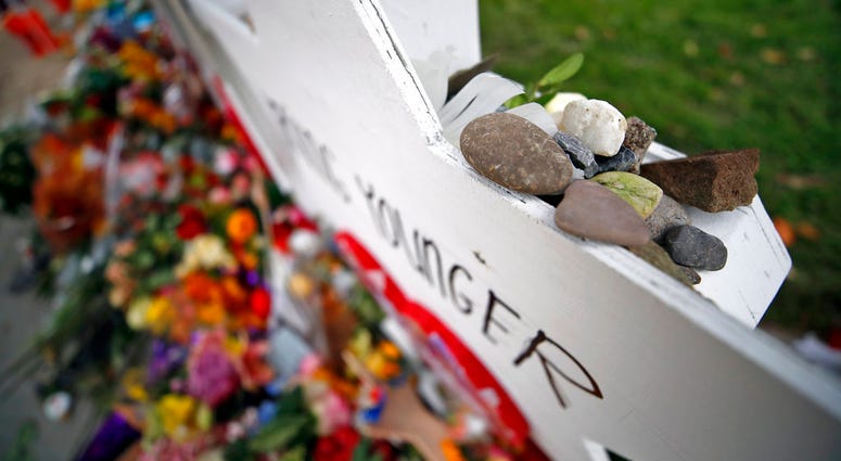 This photo shows stones placed on a memorial to Irv Younger, part of a makeshift memorial Wednesday, Oct. 31, 2018, outside the Tree of Life Synagogue, to the 11 people killed during worship services Saturday in Pittsburgh. (AP Photo/Gene J. Puskar)