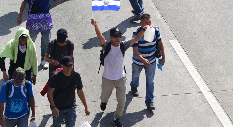 Migrants from El Salvador start on their way to the United States, in San Salvador, El Salvador, Wednesday, Oct. 31, 2018. (AP Photo/Diana Ulloa)