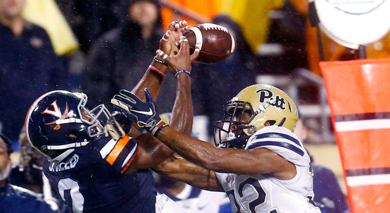 Virginia wide receiver Joe Reed (2) reaches for a pass as Pittsburgh defensive back Phillipie Motley (32) breaks it up during the first half of an NCAA college football game in Charlottesville, Va., Friday, Nov. 2, 2018