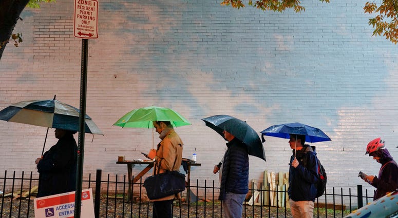 A line forms outside a polling site on election day in Atlanta, Tuesday, Nov. 6, 2018.