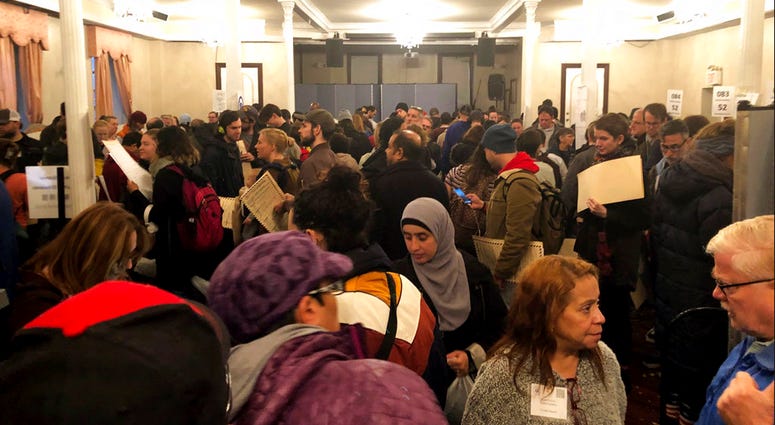 People stand on numerous lines as they wait to vote at Kingsboro Temple Seventh-day Adventist Church in the Brooklyn borough of New York on Tuesday, Nov. 6, 2018. (Courtesy of Brad Lander via AP)
