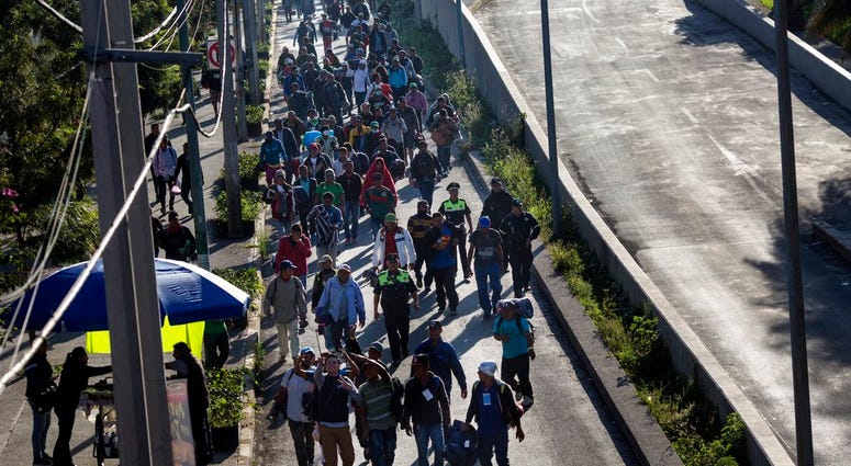 A group of Central American migrants resume their journey north after leaving the temporary shelter at the Jesus Martinez stadium, in Mexico City,
