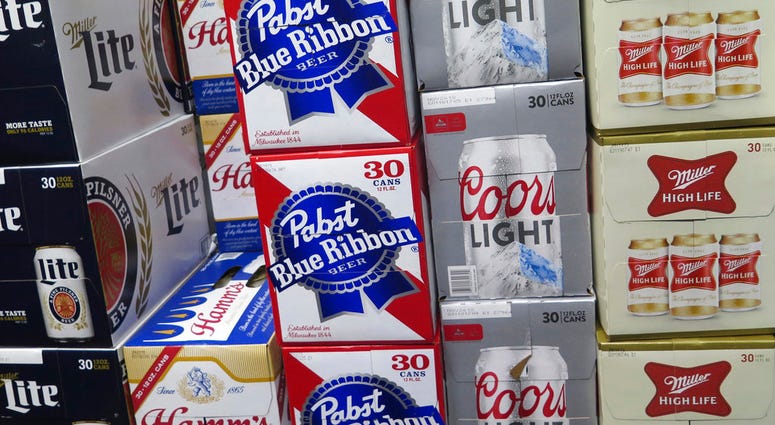 In this photo taken on Thursday, Nov. 8, 2018, cases of Pabst Blue Ribbon and Coors Light are stacked next to each other in a Milwaukee liquor store.