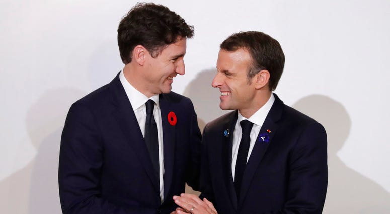 French President Emmanuel Macron, right, meets Canadian Prime Minister Justin Trudeau at the Paris Peace Forum in Paris, Sunday, Nov.11, 2018. International leaders attended a ceremony in Paris on Sunday to mark the 100th anniversary of the end of WWI
