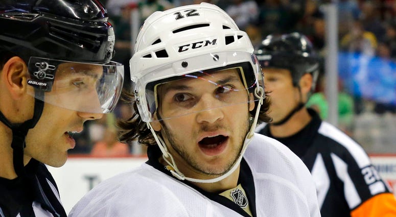 In this Sept. 29, 2014, file photo, then-Pittsburgh Penguins left wing Daniel Carcillo talks with linesman Bryan Pancich, left, during the second period of a preseason NHL hockey game against the Minnesota Wild, in St. Paul, Minn.