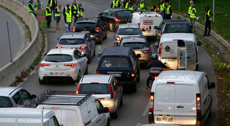 Demonstrators block a motorway exit to protest fuel tax, in Marseille, southern France, Tuesday, Nov. 17, 2018.