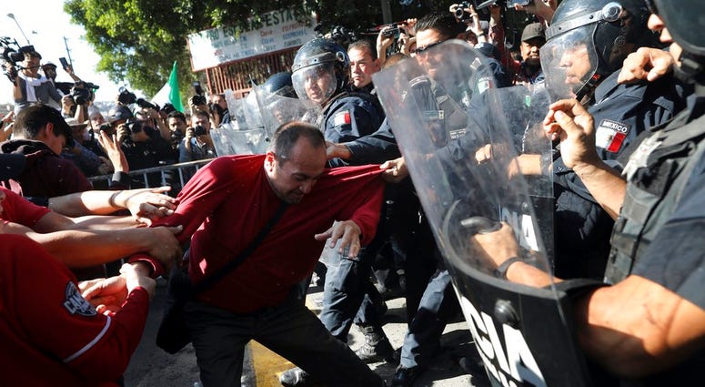 Protesters with Mexican police