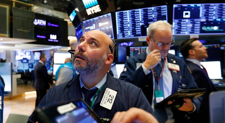 File photo trader Vincent Napolitano, left, works on the floor of the New York Stock Exchange. (AP Photo/Richard Drew, File) File photo trader Vincent Napolitano, left, works on the floor of the New York Stock Exchange. (AP Photo/Richard Drew, File)