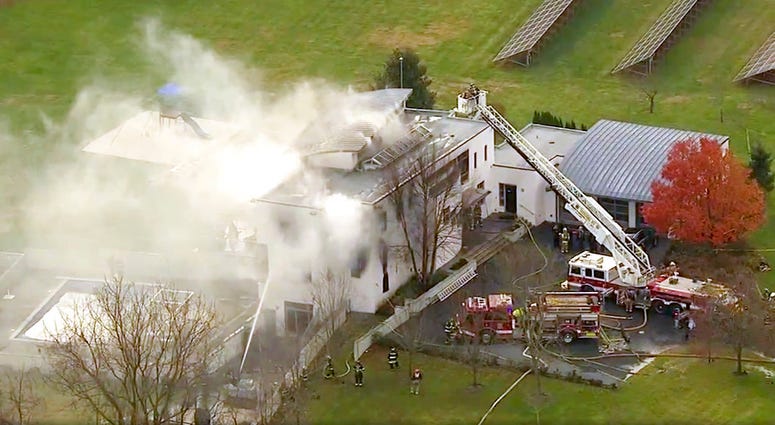 In this image made from a video provided by WABC firefighters battle a fatal fire on Tuesday, Nov. 20, 2018, in Colts Neck, N.J. The Monmouth County prosecutor's office says the fire has taken multiple victims.