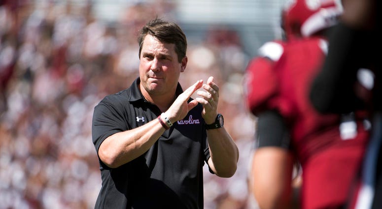 In this Sept. 8, 2018, file photo, South Carolina head coach Will Muschamp watches players before an NCAA college football game against Georgia, in Columbia, S.C. South Carolina