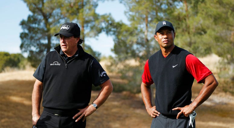 hil Mickelson, left, and Tiger Woods stand at the first tee before a golf match at Shadow Creek golf course, Friday, Nov. 23, 2018, in Las Vegas.