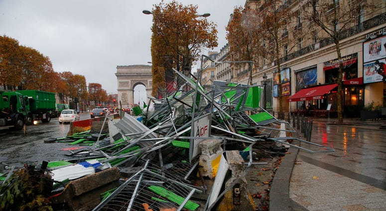 A barricade lays on the side at the Champs Elysees avenue in Paris, France, Sunday, Nov 25, 2018, in the aftermath of a protest against the rising of the fuel taxes