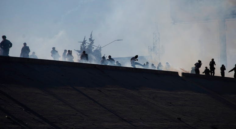 U.S. Border agents fire tear gas at migrants