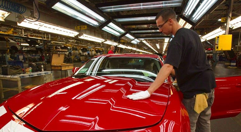 - In this June 10, 2011, file photo, a worker checks the paint on a Camaro at the GM factory in Oshawa, Ontario. General Motors is closing a Canadian plant at the cost of about 2,500 jobs