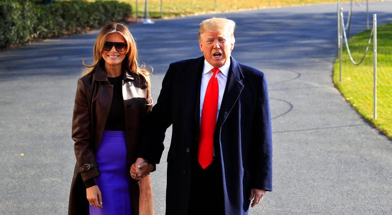 President Donald Trump asks first lady Melania Trump to join him as he concludes talking to reporters on the South Lawn before leaving the White House in Washington, Thursday, Nov. 29, 2018. (AP Photo/Manuel Balce Ceneta) President Donald Trump asks first lady Melania Trump to join him as he concludes talking to reporters on the South Lawn before leaving the White House in Washington, Thursday, Nov. 29, 2018. (AP Photo/Manuel Balce Ceneta)
