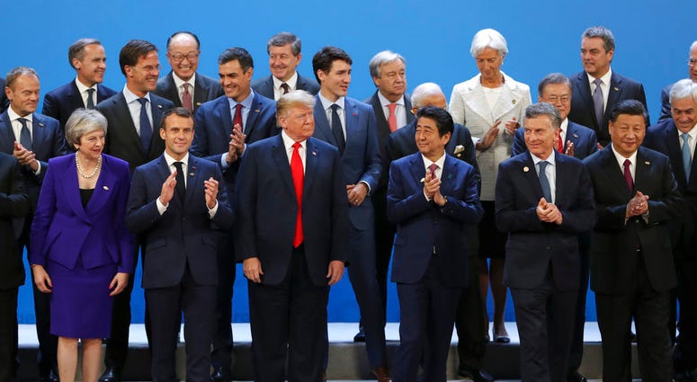 World leaders gather for a group photo at the start of the G20 Leader's Summit at the Costa Salguero Center in Buenos Aires, Argentina, Friday, Nov. 30, 2018.