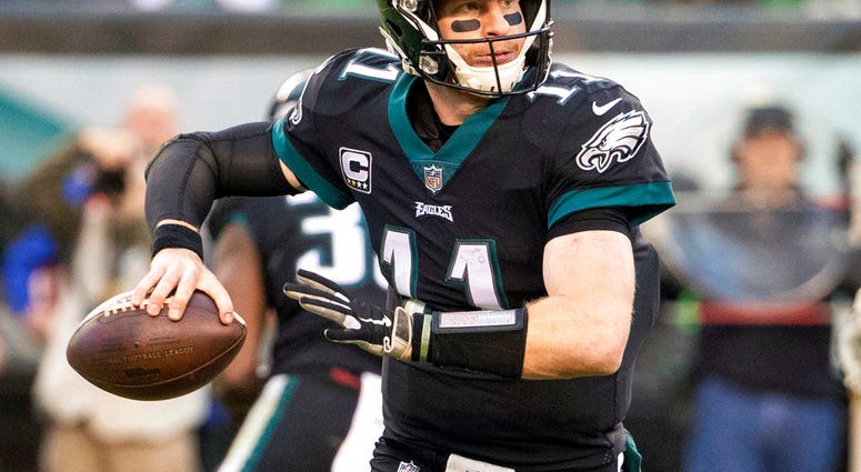 In this Nov. 25, 2018, file photo, Philadelphia Eagles quarterback Carson Wentz looks to pass