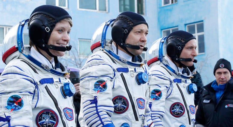U.S. astronaut Anne McClain, left, Russian cosmonaut Оleg Kononenko, centre, and CSA astronaut David Saint Jacques,