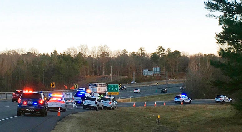 Emergency vehicles are parked along Interstate 30 near the scene where a charter bus that was carrying a youth football team from Tennessee crashed early Monday, Dec. 3, 2018, near Benton, Ark.