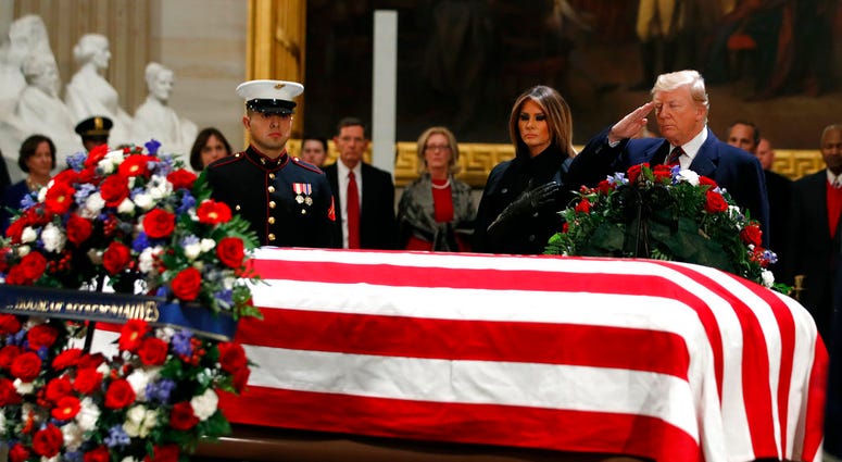 President Trump salutes casket of George H.W. Bush