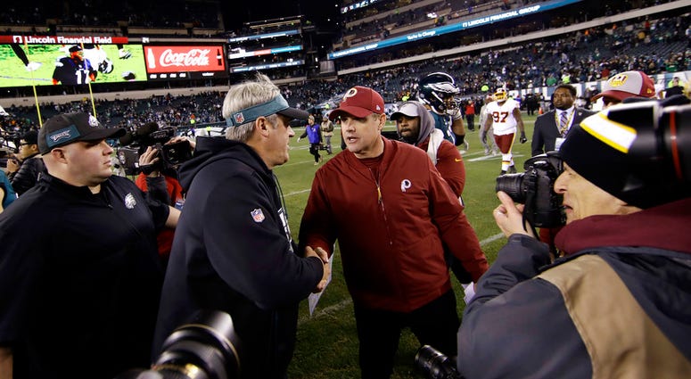 Philadelphia Eagles' Doug Pederson, left, and Washington Redskins' Jay Gruden meet after an NFL football game, Monday, Dec. 3, 2018, in Philadelphia. Philadelphia won 28-13.