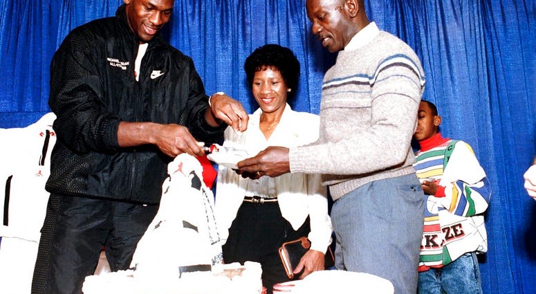FILE- In this Feb. 17, 1989 file photo, Chicago Bulls' Michael Jordan serves his father, James, a slice of birthday cake as his mother, Doloris, watches during a party in honor of Jordan's 26th birthday in Chicago, Ill. (AP Photo/Charles Bennett, File) FILE- In this Feb. 17, 1989 file photo, Chicago Bulls' Michael Jordan serves his father, James, a slice of birthday cake as his mother, Doloris, watches during a party in honor of Jordan's 26th birthday in Chicago, Ill. (AP Photo/Charles Bennett, File)