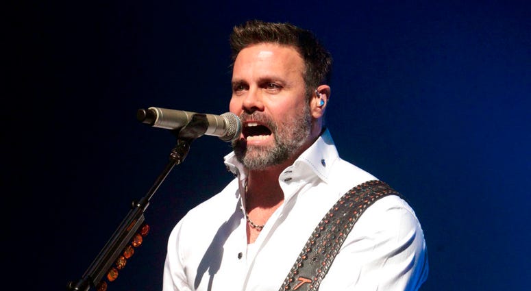 In this Jan. 17, 2013 file photo, Troy Gentry of the Country Music duo Montgomery Gentry performs on the Rebels On The Run Tour in Lancaster, Pa.