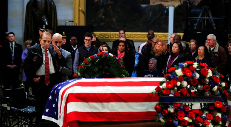 Bob Dole salutes casket of George H.W. Bush