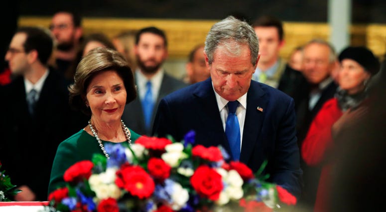 Laura & George W Bush with George H.W. Bush casket