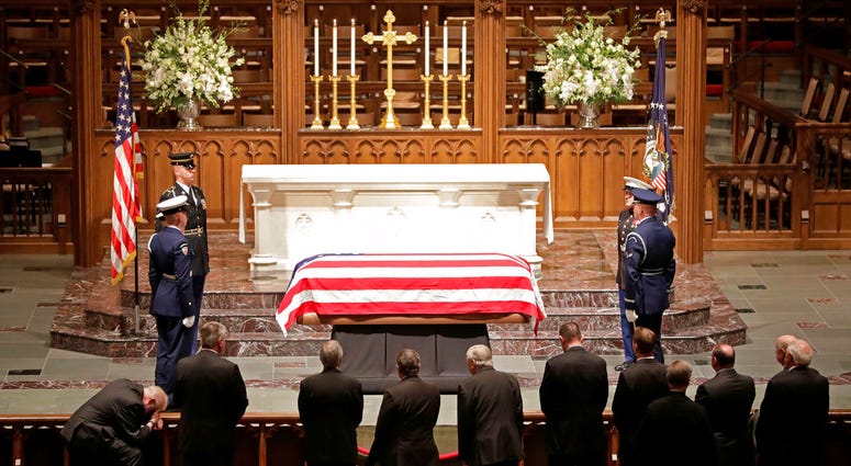 Mourners in Houston file past casket of George H.W. Bush
