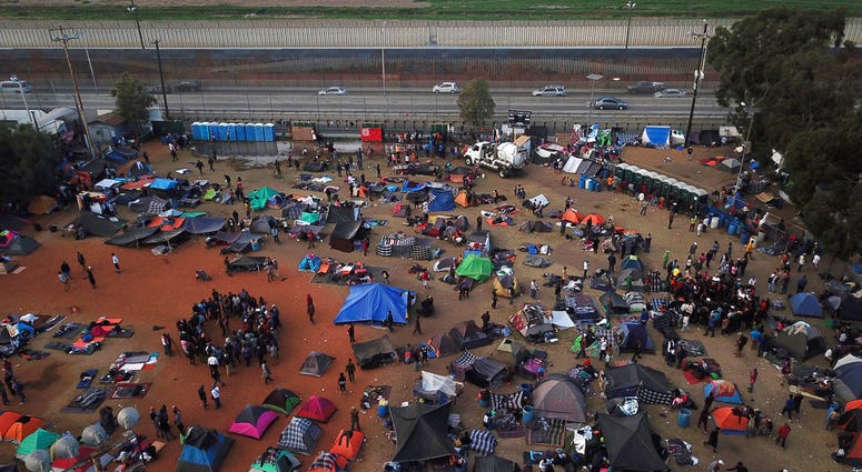 - In this Wednesday, Nov. 21, 2018 file photo, Central American migrants gather at a temporary shelter, near barriers that separate Mexico and the United States, in Tijuana, Mexico.