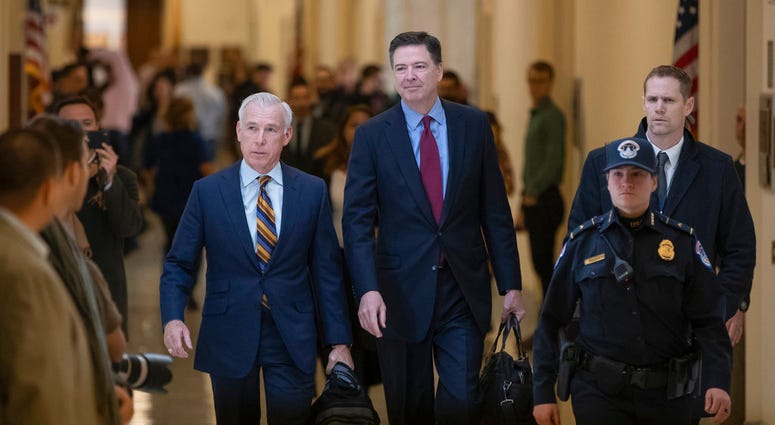Former FBI Director James Comey, with his attorney, David Kelley, left, arrive to testify under subpoena behind closed doors before the House Judiciary and Oversight Committee in Washington, Friday, Dec. 7, 2018. (AP Photo/J. Scott Applewhite)