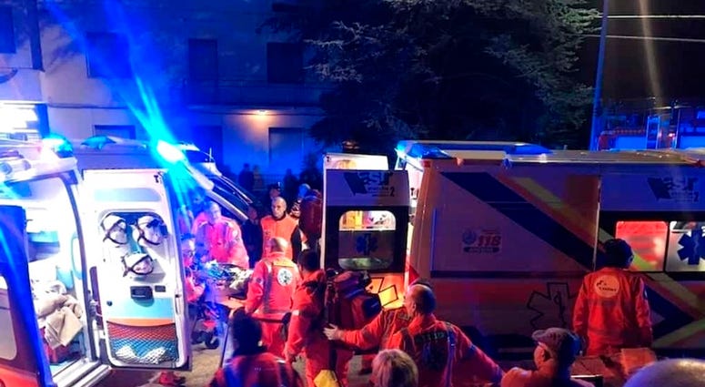 Rescuers assist injured people outside a nightclub in Corinaldo, central Italy, early Saturday, Dec. 8, 2018.